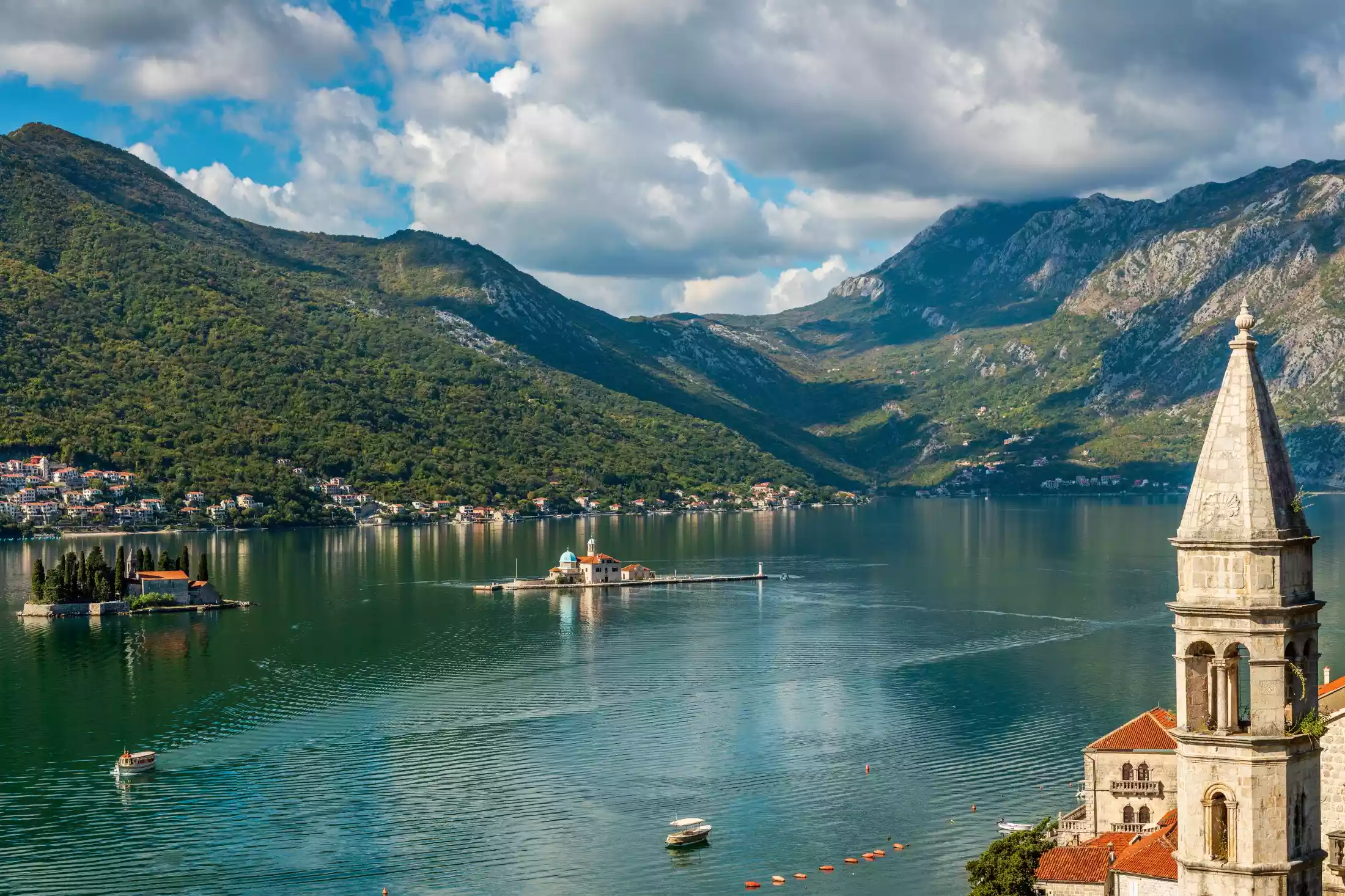 A view of Perast Montenegro from above, showing Our Lady of the Rocks island, the Gospa od Škrpjela Church situated on the island of St. George and the St. Nicholas church's bell tower.