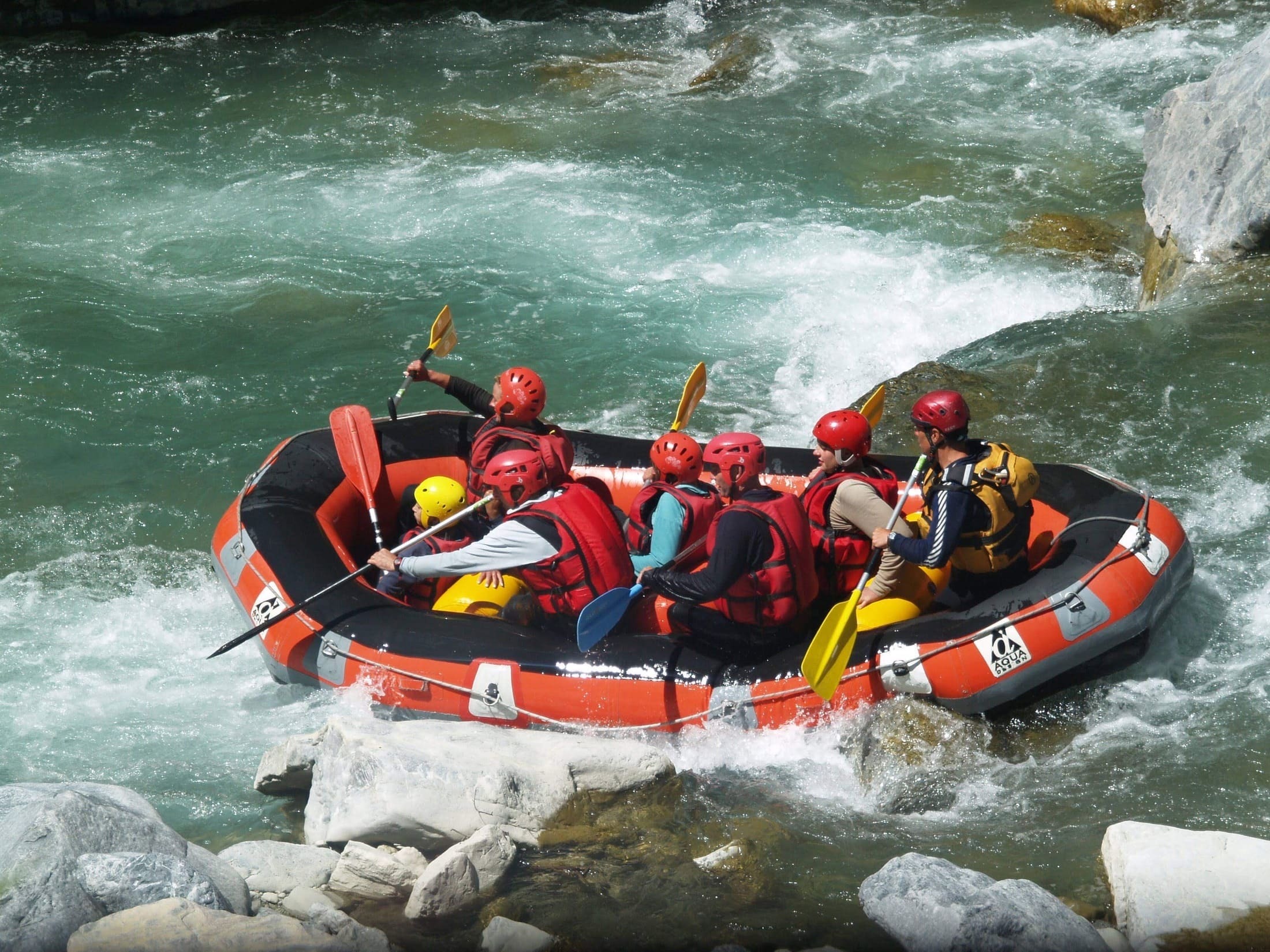 A photo of a group of tourists rafting