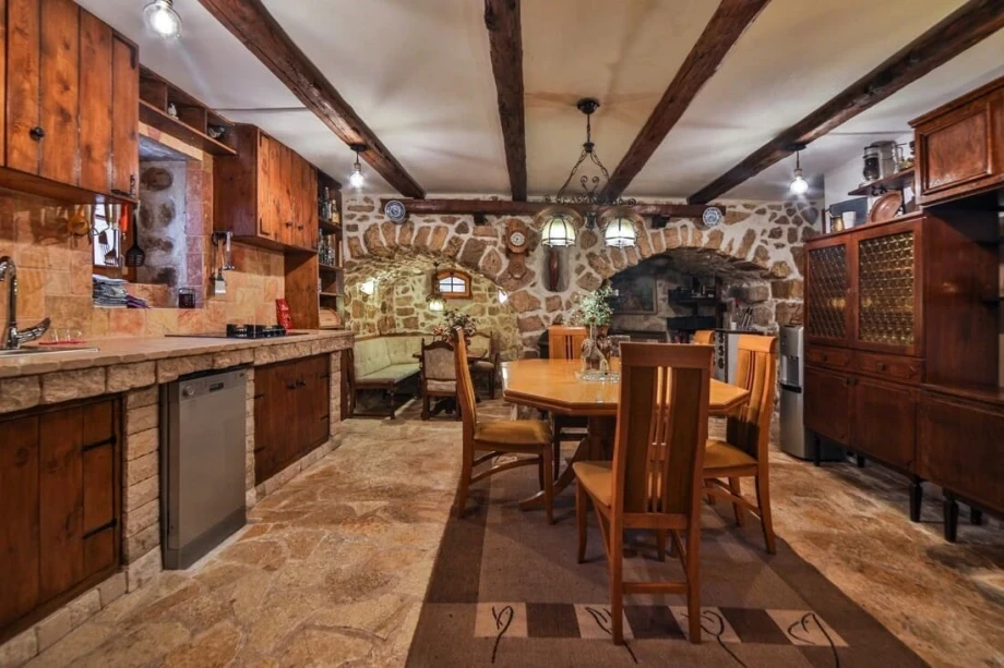 A photo of a traditionally decorated dining room and kitchen in Montenegro