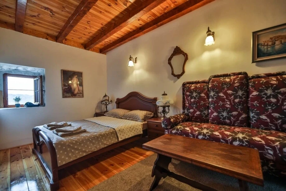 Bedroom with a double bed and many rustic elements