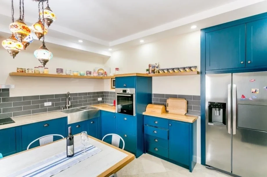 Kitchen with an incredible blue decor inside Azure Hideaway villa