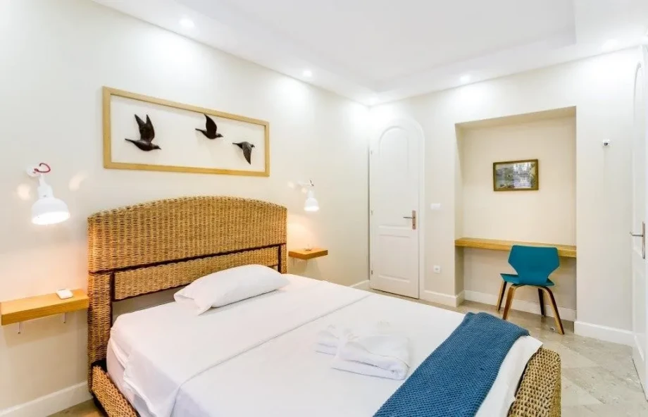 Master bedroom with a bird picture on the wall, in a Montenegro villa for rent