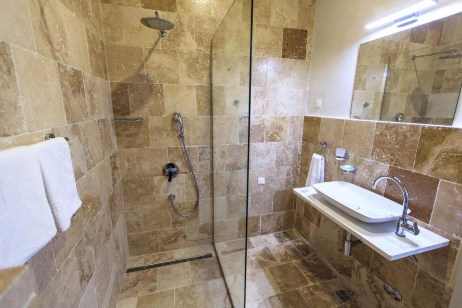 Bathroom with shower cabin and sink in a villa for rent in Montenegro