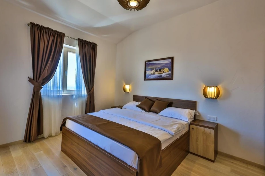 Bedroom with double bed in a luxury villa in Budva