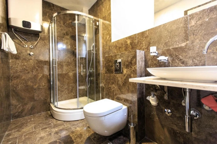Spacious bathroom with sink and shower in villa