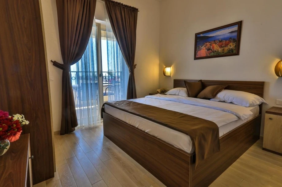 Elegant bedroom with double bed in luxury villa for rent in Montenegro