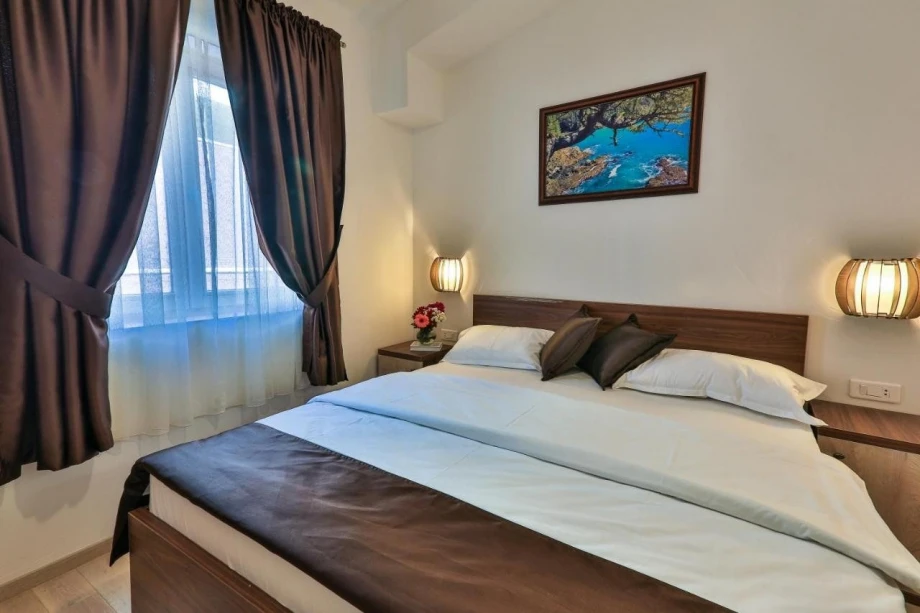 Gorgeous bedroom with a comfortable bed for two in the villa for rent in Montenegro