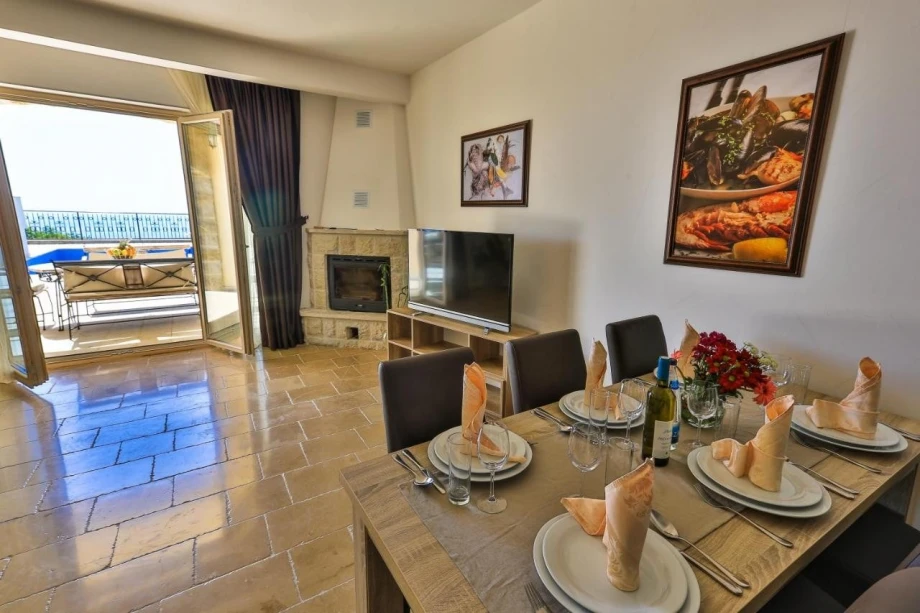Dining area with fireplace in elegant villa Sunny Orchid