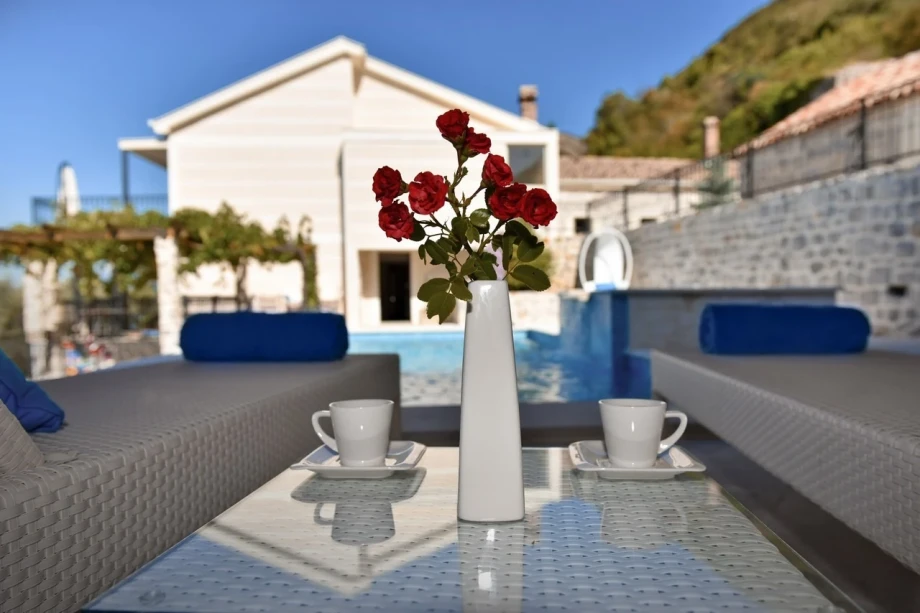 Coffee by the pool with roses at Estate Villa in Kotor