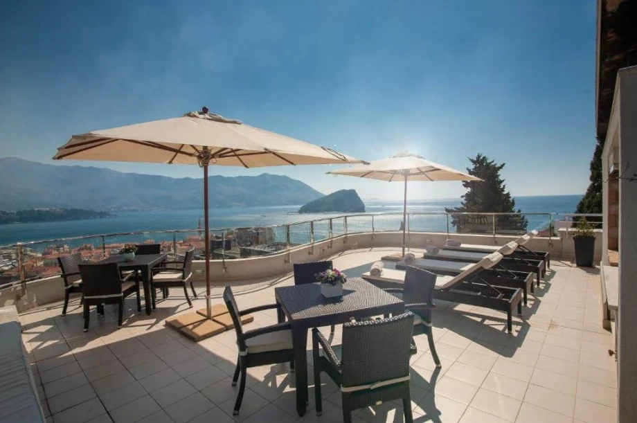 Spacious terrace with sunbeds and a mesmerising view of the Old Town in Budva