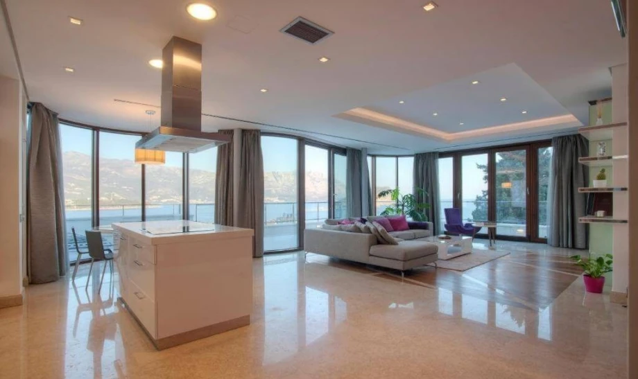 Huge living room with a kitchen island inside the luxury villa apartment in Budva