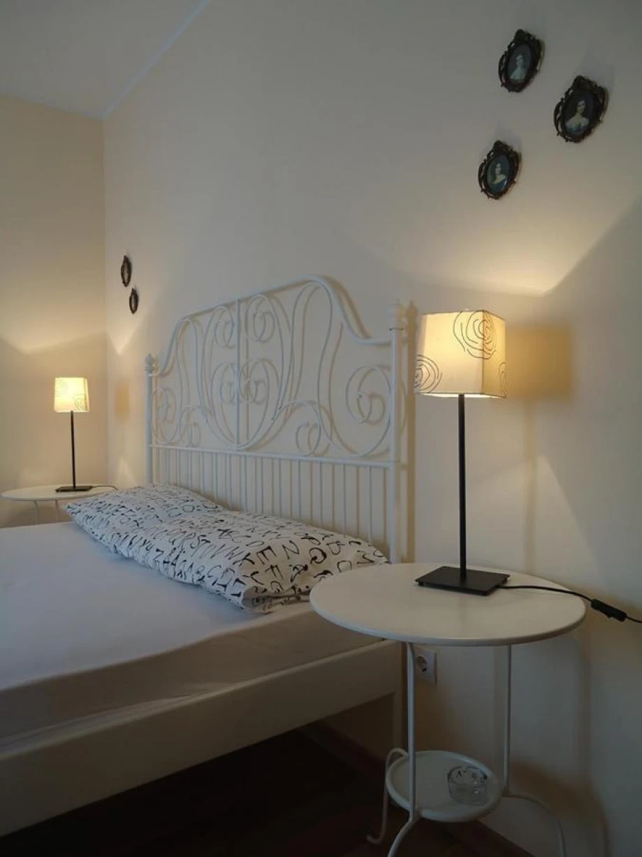 Modern furnished room with a white bed and lamps creating a relaxing atmosphere