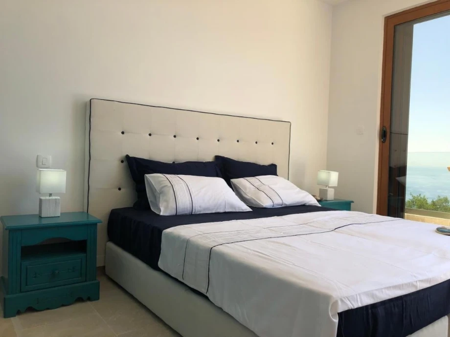 Luxury bedroom with a double bed in a villa for rent in Montenegro