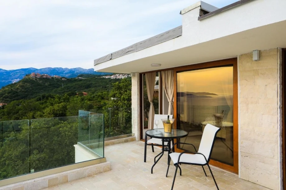 Villa patio with a table and spectacular views of the hills surrounding Budva
