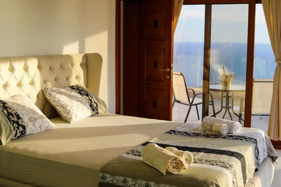 Sunny bedroom with terrace access inside villa Blissful Retreat