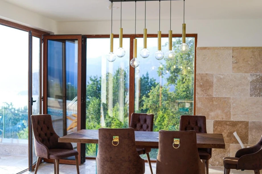 Dining room with a big table inside Blissful Retreat luxury villa for rent in Budva