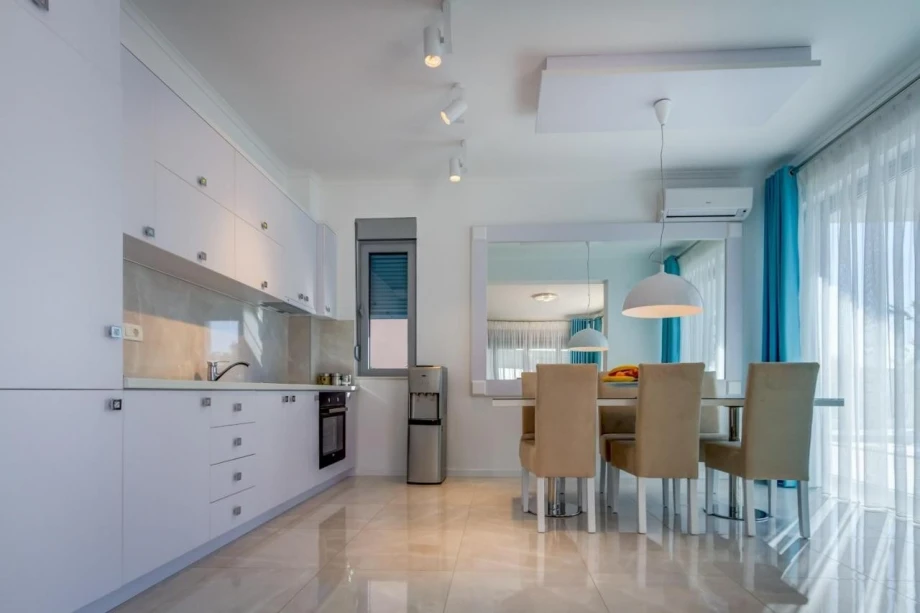 Spacious pearly-white kitchen and dining room in Villa Danika in Montenegro