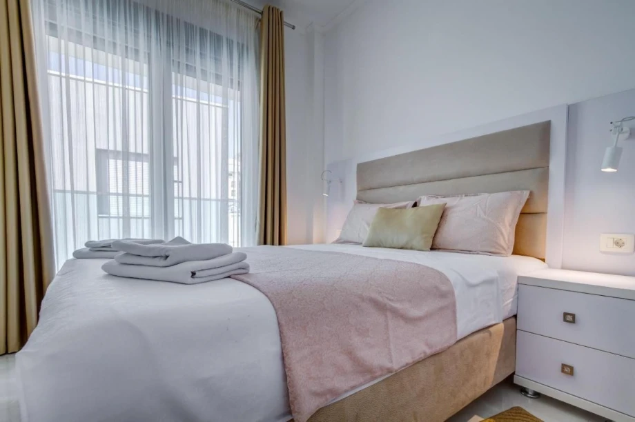 Large comfortable bed in light tones in the luxurious Villa Danika in Montenegro