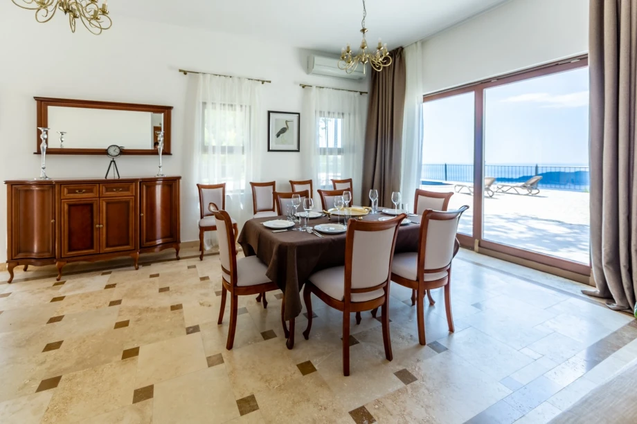 Dining room with a panoramic window and a view of the pool