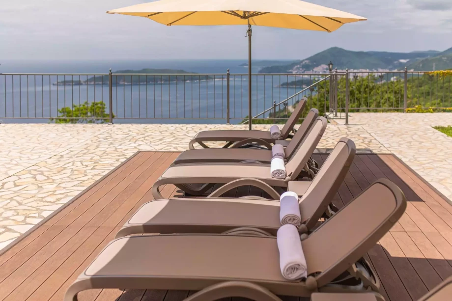 Sunchairs by the pool in luxury villa Reef Tree in Montenegro