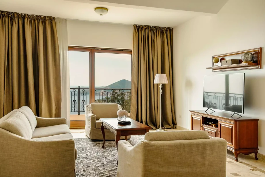 Living room with a TV and access to the terrace in luxury villa for rent in Budva