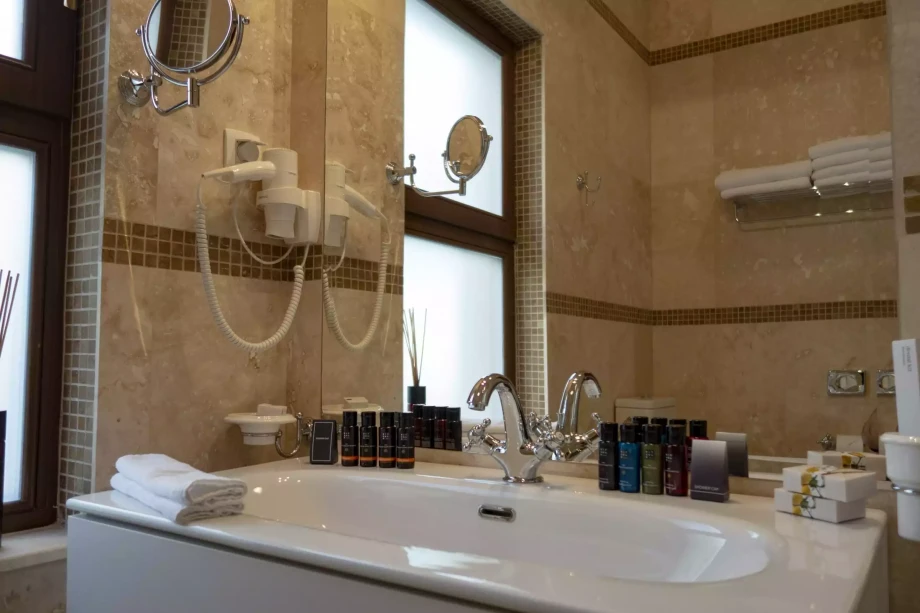 Bathroom with a bathtub and a large mirror in Villa Reef Tree in Montenegro