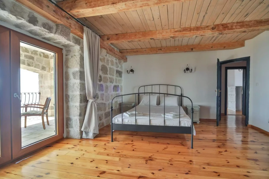 Bedroom with double bed within a luxury Montenegro villa for rent