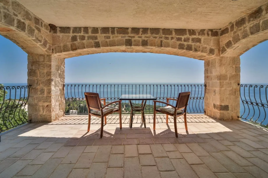 Large patio with a table and chairs and great views of the sea