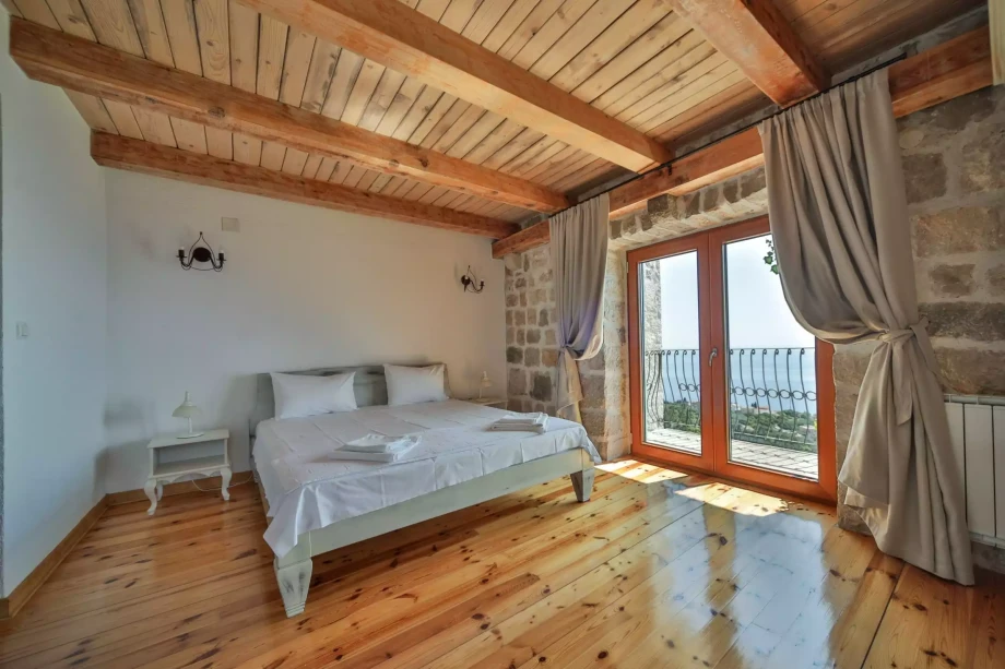 Bedroom with double bed and private terrace in elegant villa in Petrovac