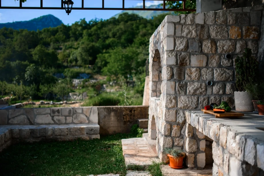 Stone fireplace inside the garden of Villa Sunray in Budva