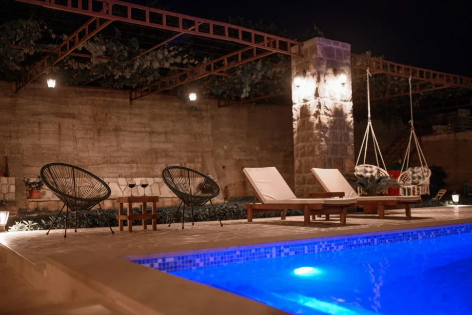 Villa Sunray and its outdoor pool at nighttime