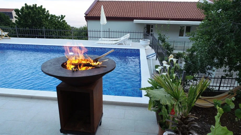 A lit bonfire by the pool of a Montenegro villa in Budva