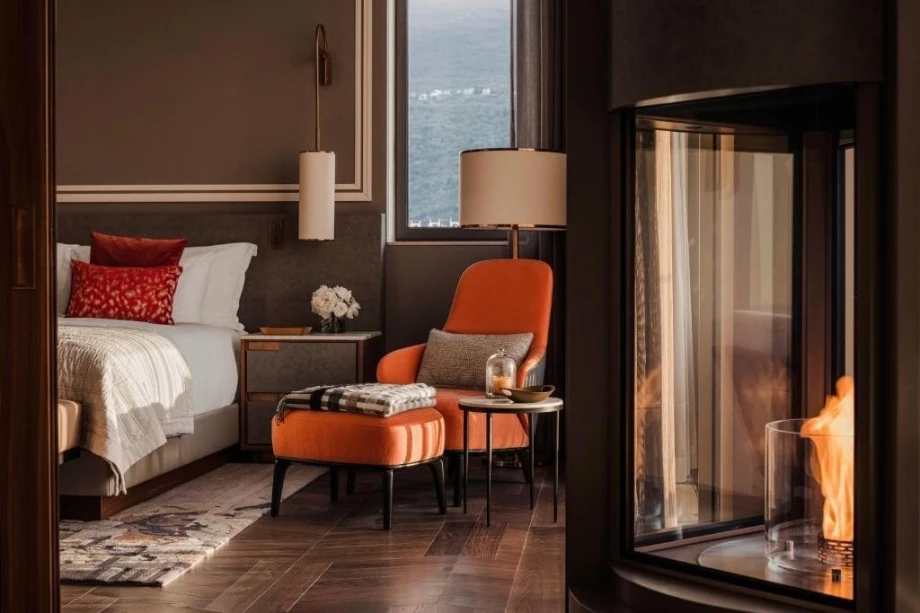 Orange armchair with lamp and a cosy fireplace, One&Only Panoramic Room in Portonovi