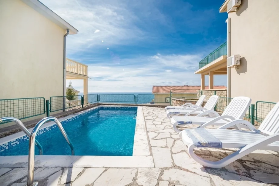 The blue of the outdoor pool and sea clash in the villa for rent Villa Krimovica 1 in Budva