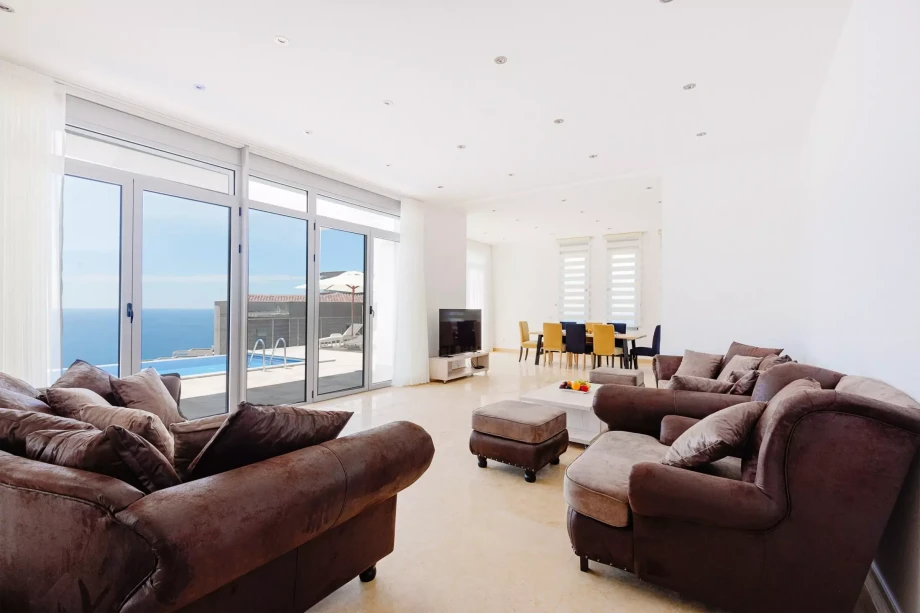 Spacious and bright living room with panoramic windows that gaze at the Adriatic Sea