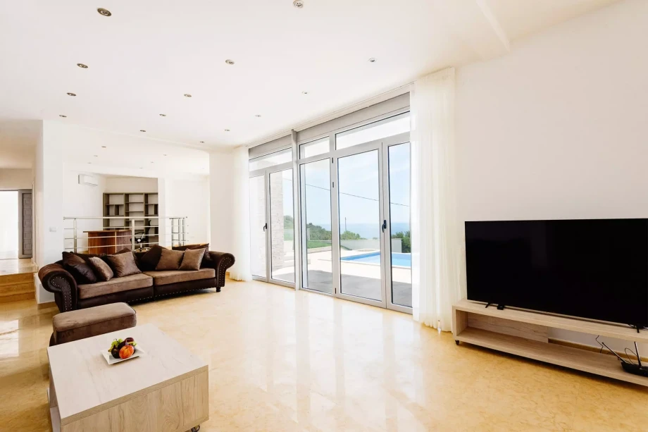 Modern and minimalistic living room with a flat-screen TV in a villa in Budva