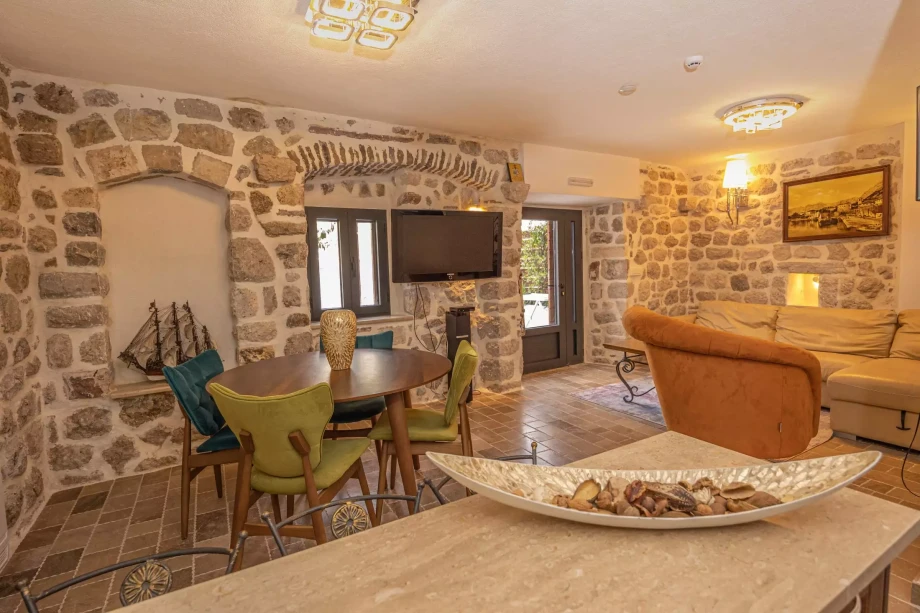 Beautifully decorated dining room in Beachfront Villa Casa di Onda Bianca with stone walls