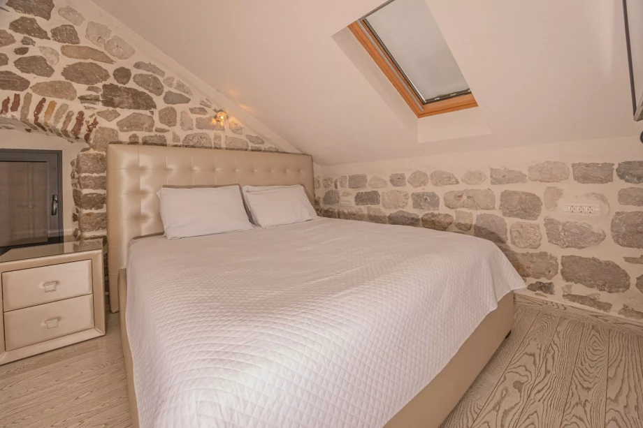Large comfortable bed inside a rustic Montenegro villa in Kotor