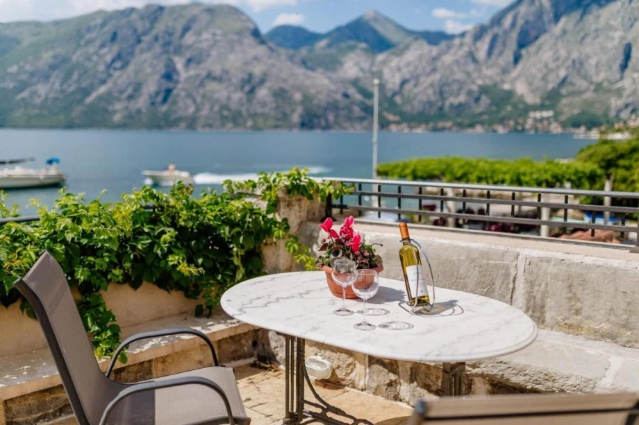 Patio with a table and a beautiful view of the sea and mountains from the elegant Kotor villa Seafront Bliss