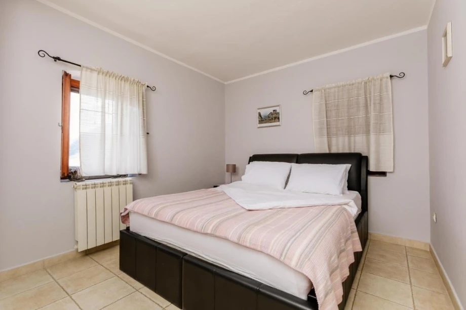 Elegant bedroom with a big and comfortable bed in a Montenegro villa in Kotor