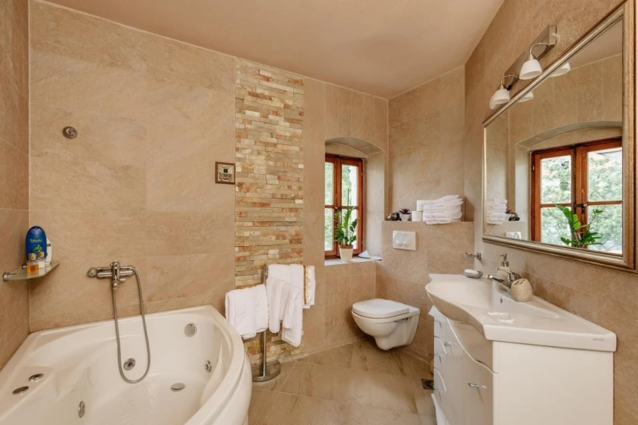 Beautiful bright bathroom with a bathtub in the elegant villa Seafront Bliss