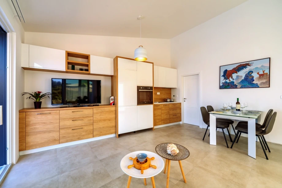 A flat screen TV and a dining area of Villa Blue Heights in Montenegro