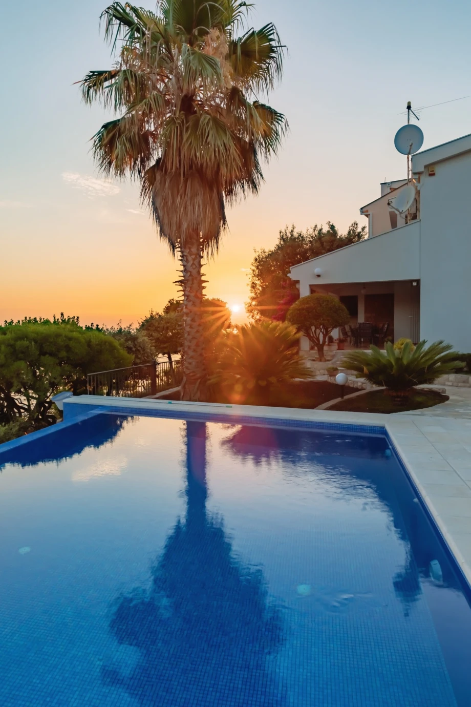 Private villa pool in Bar during a sunset