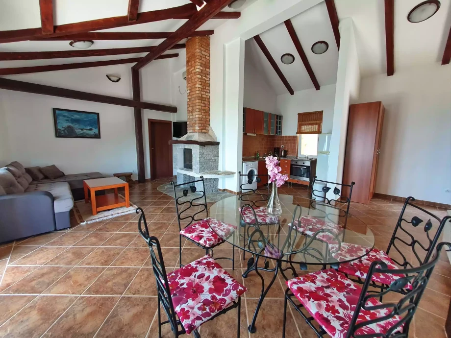 Living room, dining room, kitchen and a fireplace, all in one comfortable space