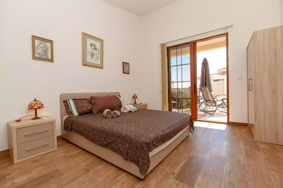 Tranquil Bedroom with Soothing Brown Linens and Terrace with Serene Views at Villa Meringue