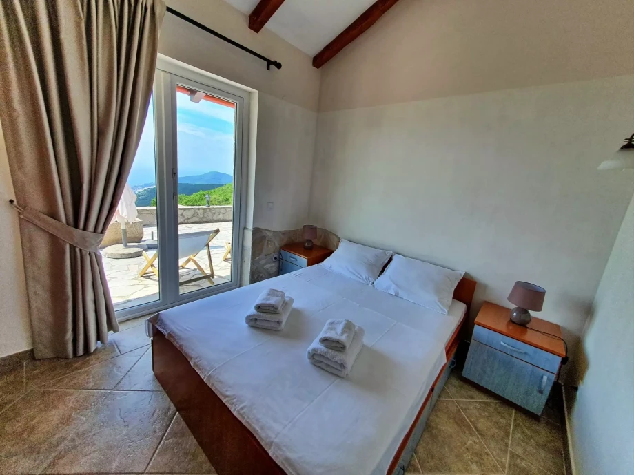 King size bedroom of a villa overlooking Budva