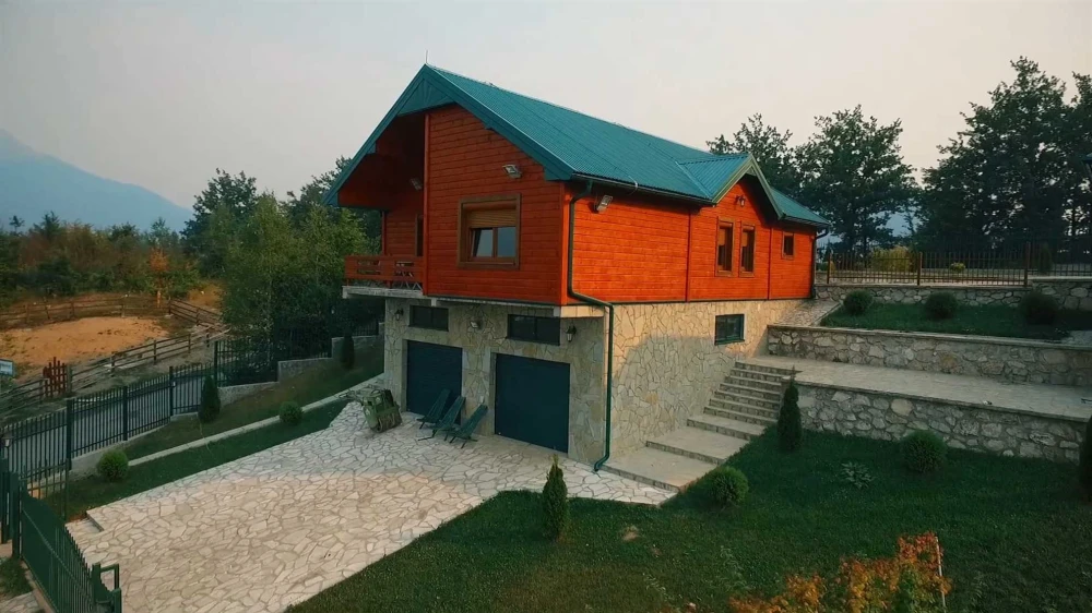 A large villa with a beautiful yard and lush greenery
