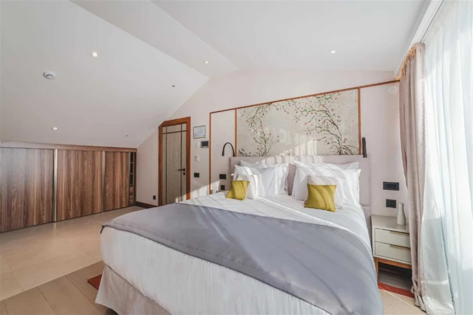 Elegant Bedroom with King-Sized Bed and Scenic Views