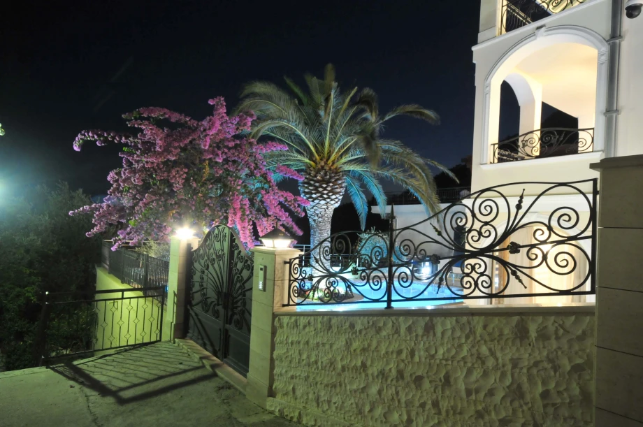 Elegant Entrance to the Villa Surrounded by Lush Landscaping