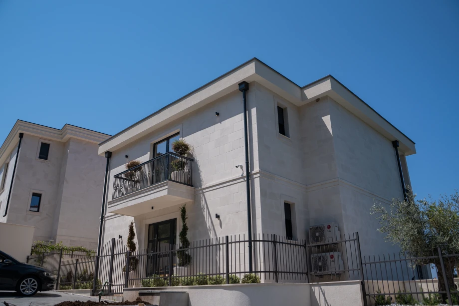 Charming Villa Exterior Surrounded by Beautiful Landscaping and Scenic Views